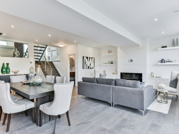 Dining table and grey sofa in a furnished living room; illustrative interior