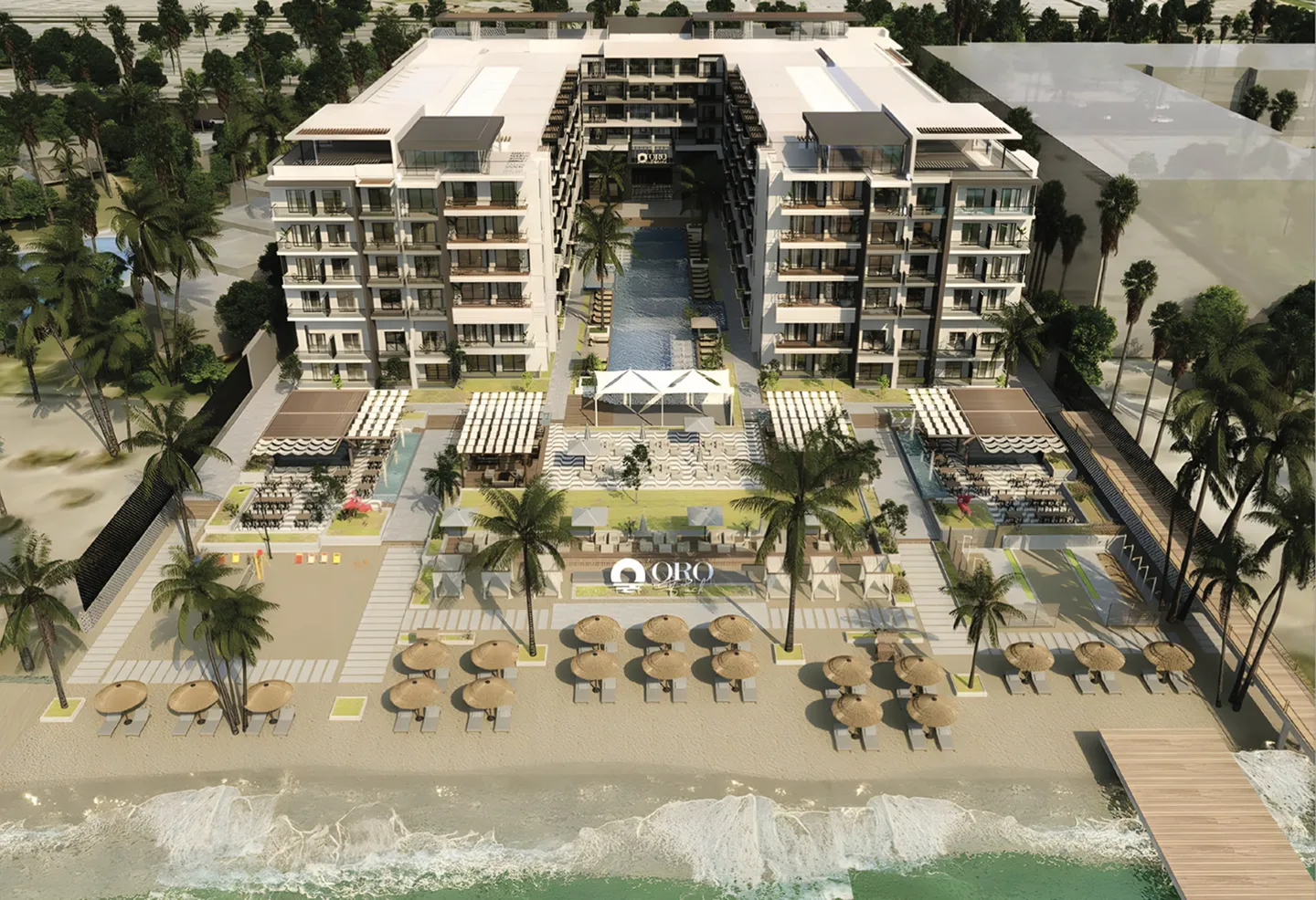 oro — developer visualisation — Aerial view of a beachfront resort featuring two six-story buildings flanking a central pool, sandy beach with umbrellas and lounge chairs, palm trees, and a wooden pier extending into the ocean.