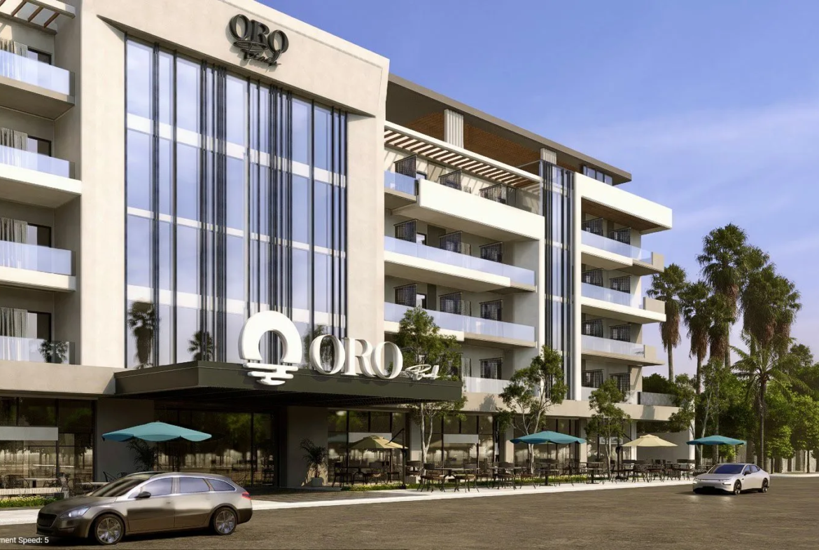 oro — developer visualisation — Modern multi-story building with balconies, outdoor seating areas with umbrellas, and two cars parked in front.