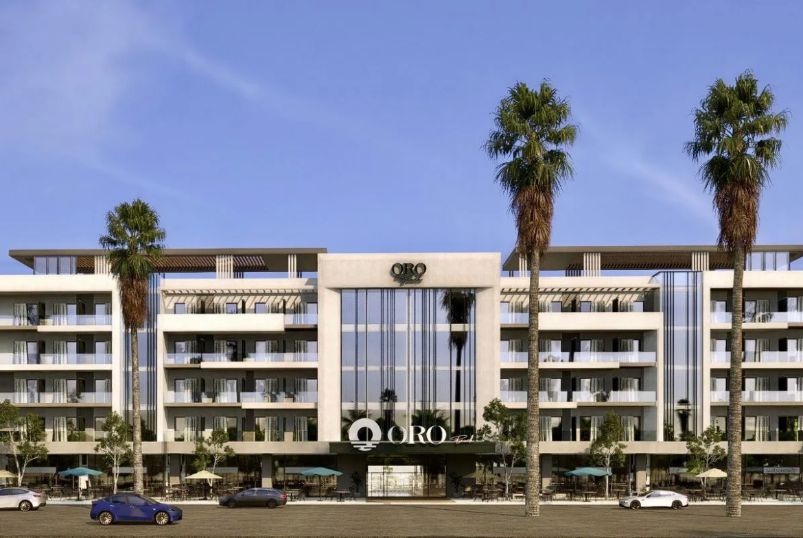 oro — developer visualisation — Modern five-story building named ORO with large glass windows, balconies, palm trees, and parked cars in front.